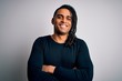 © Krakenimages.com - Young handsome african american man with dreadlocks wearing black casual sweater happy face smiling with crossed arms looking at the camera. Positive person.