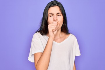 Poster - Young beautiful brunette woman wearing casual white t-shirt over purple background feeling unwell and coughing as symptom for cold or bronchitis. Health care concept.