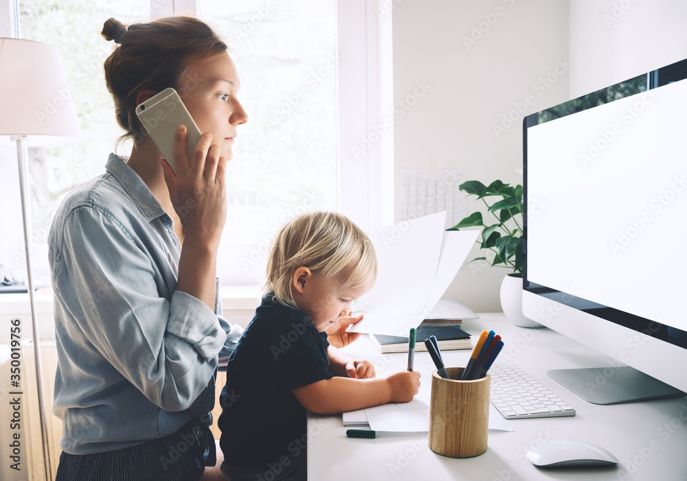 Mother working from home with little child. - obrazy, fototapety, plakaty 