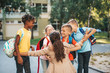 © hedgehog94 - Happy children running into hug of their teacher.
