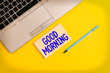 Handwriting text writing Good Morning. Conceptual photo A conventional expression at meeting or parting in the morning Trendy silver open laptop square sticky notepad marker colored background