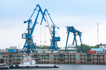 Wall Mural - Russia, Blagoveshchensk, July 2019: River station, cranes for loading operations, Blagoveshchensk in summer