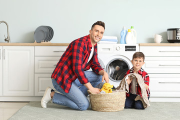 Sticker - Man and his little son doing laundry at home