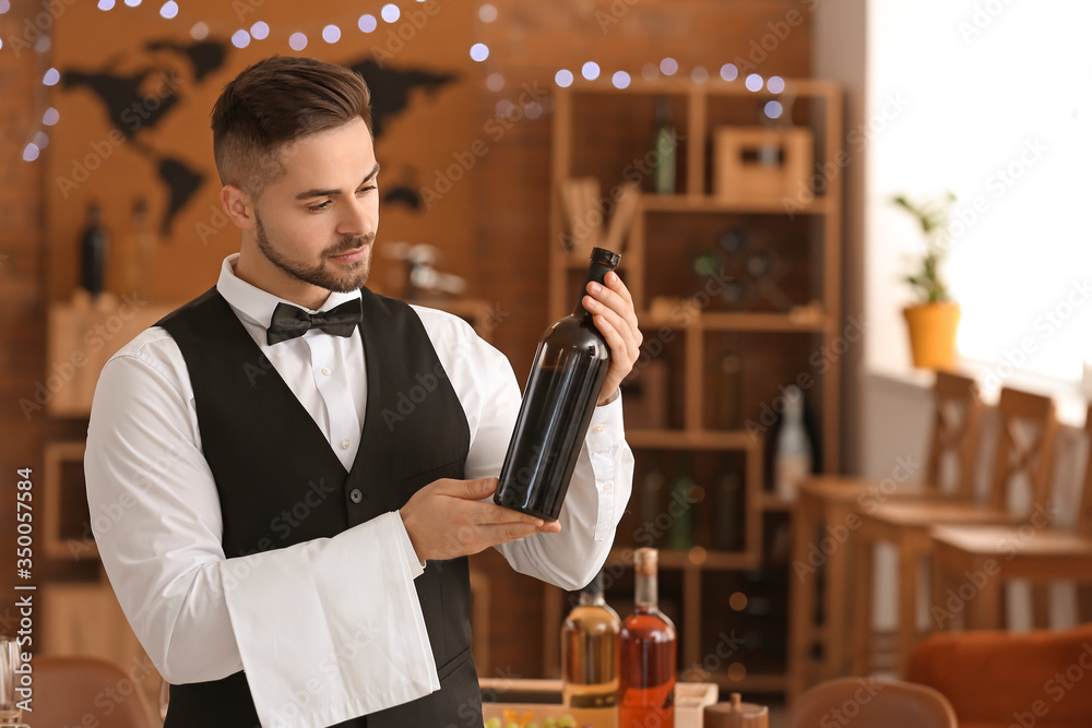 Waiter with bottle of wine at the restaurant