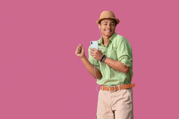 Poster - African-American teenager dancing and listening to music against color background