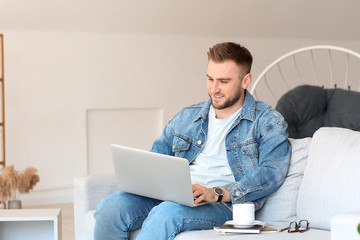 Canvas Print - Young man with laptop working at home