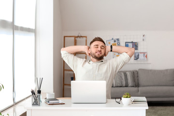 Canvas Print - Young man with laptop working at home