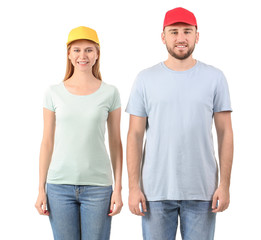 Wall Mural - Young couple in stylish caps on white background