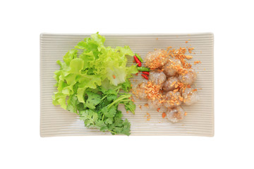 Poster - Steamed tapioca balls (Sago) with pork and peanut filling served with vegetable in plate isolated on white background, Famous traditional thai appetizer.