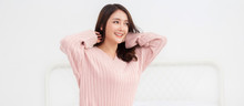 Smiling Of Cheerful Beautiful Pretty Asian Woman Clean Fresh Healthy White Skin Posing In Warm Knitted Pink Clothes.Girl Felling Relaxing And Enjoy Time On The Bed At Home.asia Beauty