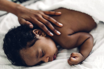 Wall Mural - Portrait of enjoy happy love family african american mother playing with adorable little african american baby.Mom touching with cute son moments good time in a white bedroom.Love of black family 