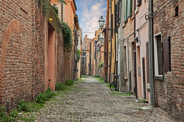 Wall Mural - Ferrara, Emilia Romagna, Italy: old alley in the downtown of the ancient Italian city