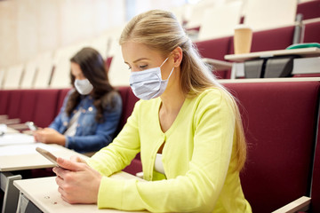 education, healthcare and pandemic concept - student girls wearing face protective medical masks for