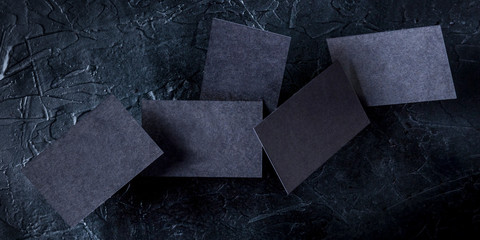 Wall Mural - Thick black business cards panorama, flying on a dark background, a mockup for a creative design presentation
