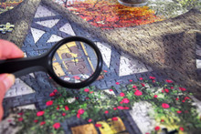 A Lens Magnifying Pieces Of Jigsaw Puzzle, Close Up