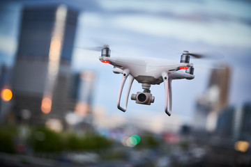 Wall Mural - drone quadcopter with digital camera flying at city street