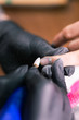 © satura_ - Close-up of manicurist woman removes gel shellac polish from client's nails using manicure machine. Manicure master is working with electric nail drill in beauty salon. Hardware manicure process.