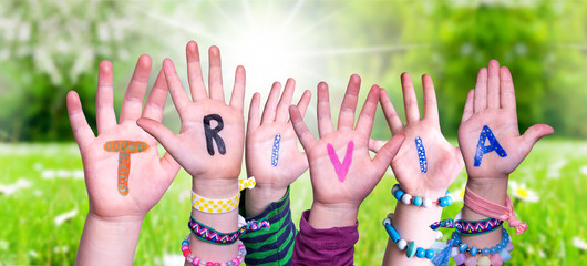 Wall Mural - Children Hands Building Colorful English Word Trivia. Sunny Green Grass Meadow As Background