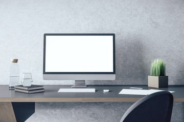 Designer desktop with empty white computer screen