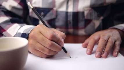 Poster - A male hands writing on a piece of paper. Writing essay or letters. Work from home concept.