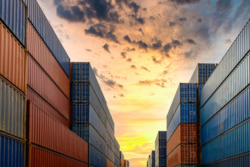 Industrial container yard for business commercial trade logistic transportation oversea worldwide Import Export, Stack of colorful cargo freight ship container at sunset background.