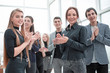 © ASDF - young employees applauding together standing in the office .