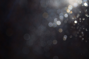 bokeh of water fly and lights on black background,