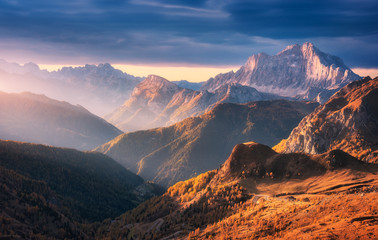 Wall Mural - beautiful mountains at sunset in autumn in dolomites, italy. landscape with rocks, sunbeams, forest,