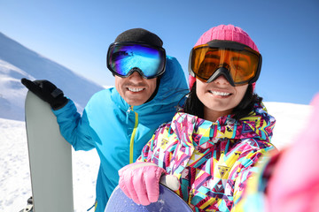 Wall Mural - Couple taking selfie on hill. Winter vacation