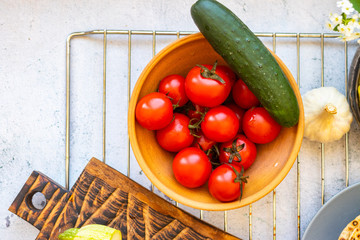 Fresh ripe red cherry tomatoes and green cucumbers vegetables. Vegan organic food