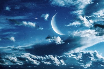 Wall Mural - the night sky and the stars in the clouds. new moon background