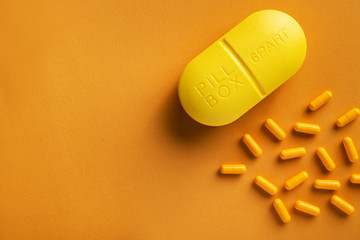 Wall Mural - yellow container with pills