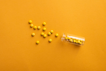 Wall Mural - Closeup of small round pills with glass bottle