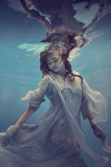 Wall Mural - Portrait of a girl in a blue dress under water