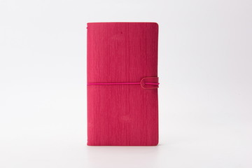 Rose red leather notebook isolated on a white background