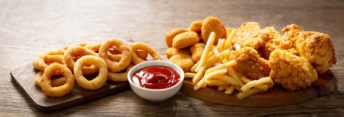 Canvas Print - fast food meals : onion rings, french fries, chicken nuggets and fried chicken