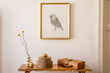 © FollowTheFlow - Stylish concept at living room interior with gold mock up frame, wooden bench, boxes, dried flowers in vase, white wall and elegant personal accessories in modern home decor.