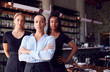 © Monkey Business - Portrait Of Female Owner Of Restaurant Bar With Team Of Waiting Staff Standing By Counter