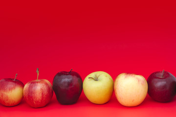 apples on red background many delicious fresh fruits 