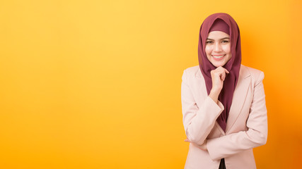 Wall Mural - Beautiful business woman with hijab portrait on yellow background