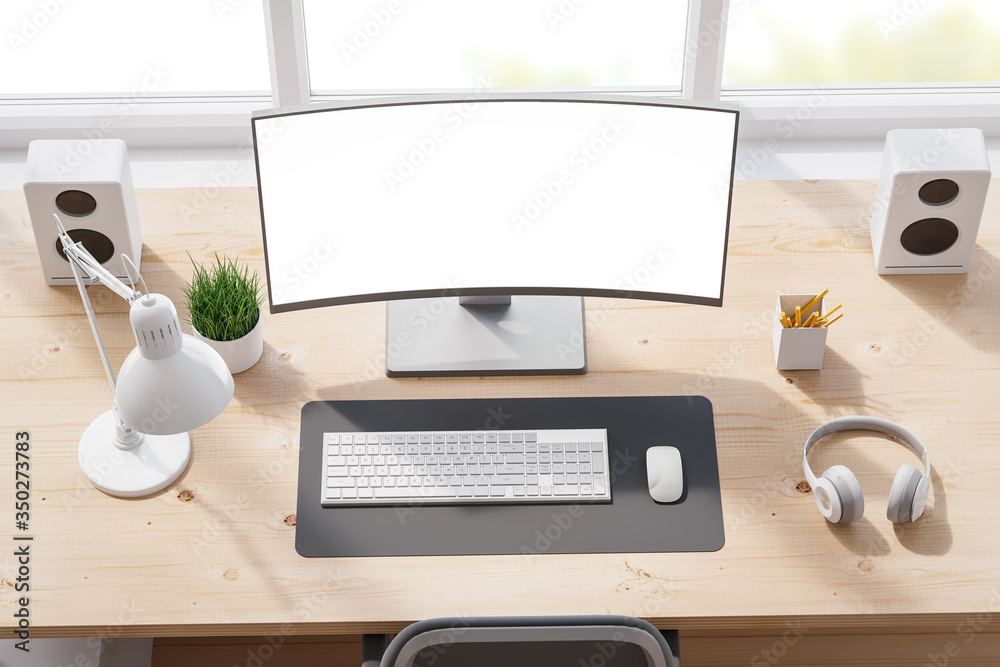 Top view of the workspace with an empty computer monitor, keyboard ...