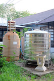 Fototapeta  - Old fiber water tank and metal water tank at building out door.