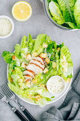 Wall Mural - Traditional Caesar salad with chicken, romaine lettuce, croutons and parmesan cheese.