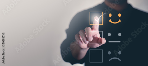 Fotografía Customer service and Satisfaction concept ,Business people are touching the virtual screen on the happy Smiley face icon to give satisfaction in service