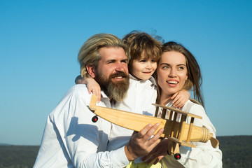 Wall Mural - Happy family outdoors. Happy young couple with male children outdoors. Family parenthood and people concept. Travel, vacation and freedom. Son hugging parents on nature.