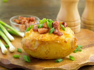 Wall Mural - Stuffed baked potatoes with cheese and bacon with sour cream.