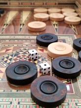 Backgammon With Wooden Inlay. Wooden Backgammon Board Game Of Pearl Inlaid On Brown Background.