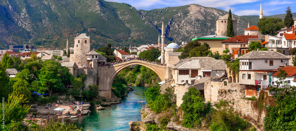 Beautiful iconic old town Mostar with famous bridge in Bosnia and Herzegovina, popular tourist destination - obrazy, fototapety, plakaty 