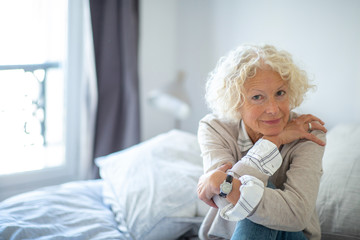 Wall Mural - older woman sitting at home alone