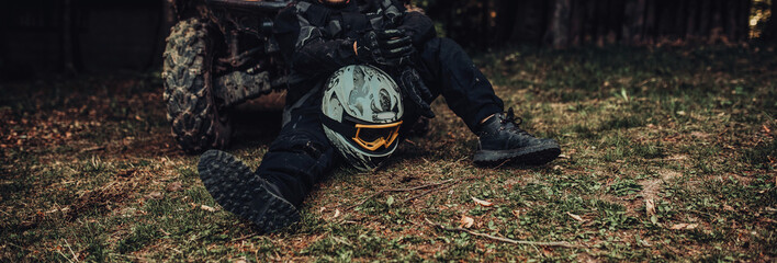 Man sitting and preparing equipment for extreme quad ride